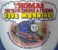 picture on egg cup 2: it says, 'thomas the tank engine and friends. good morning!' and there is a picture of a blue train with a face