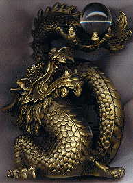front view of chinese brass dragon with glass pearl