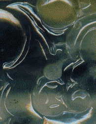 chinese jade pendant: closeup of curlicues on back, showing fine carving