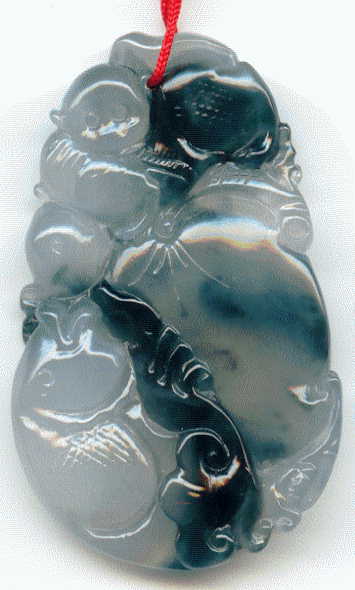 large jade pendant: front view showing monkey with fruit and fish