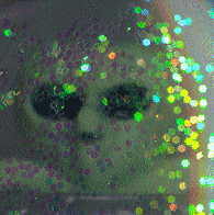 chinese glitter-shaker with alien: closeup of alien face