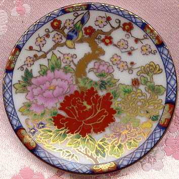 tiny plate decorated with flowers and bird