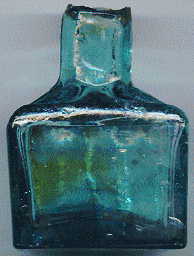 victorian pale green glass ink bottle with a few bubbles and attractive ink stains: back view