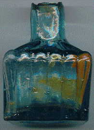 victorian pale green glass ink bottle with a few bubbles and attractive ink stains: front view