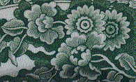 closeup of flowers from border of green/white plate