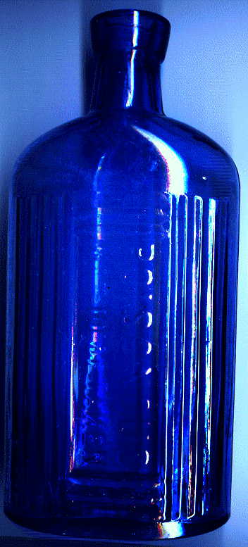 large blue victorian poison bottle: it says POISONOUS. NOT TO BE TAKEN