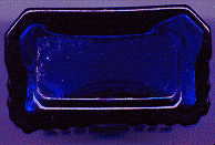 tiny cobalt blue rectangular victorian ntbt poison bottle: base view