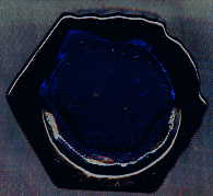 small blue octagonal blue poison bottle: base view