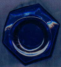 small blue octagonal poison bottle: top view